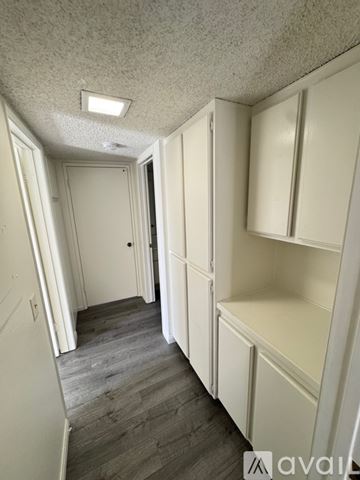 Azusa condo for rent - A kitchen with wooden cabinets and white appliances.