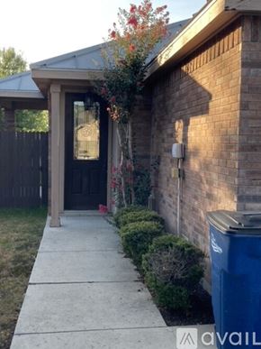 New Braunfels house for rent - A house with a black door and a blue trash can.