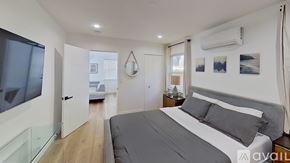 Los Angeles apartment for rent - A bedroom with a large bed and a glass table.