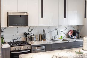 Los Angeles apartment for rent - A kitchen with a black microwave above the stove.