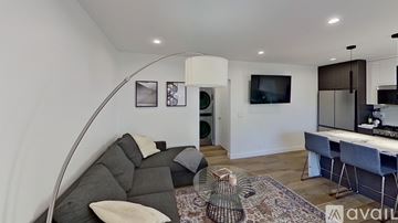 Los Angeles apartment for rent - A living room with a grey couch and a white chair.