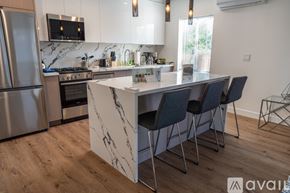 Los Angeles apartment for rent - A kitchen with a marble island and modern appliances.
