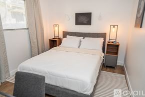 Los Angeles apartment for rent - A bedroom with a large bed and two lamps on side tables.