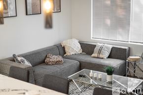 Los Angeles apartment for rent - A grey couch with a glass coffee table in front of it.
