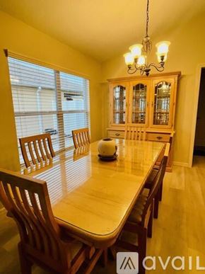 The Villages house for rent - A dining room with a wooden table and chairs.