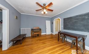 Cleveland Heights house for rent - A room with a ceiling fan and wooden flooring.
