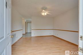 Johnson City townhouse for rent - A room with wooden floors and a ceiling fan.