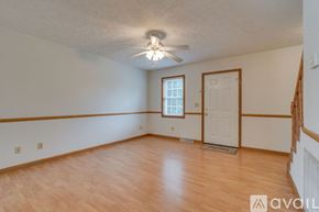 Johnson City townhouse for rent - A room with wooden flooring and a ceiling fan.