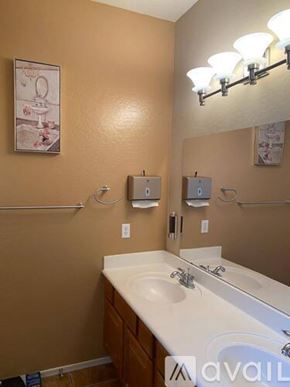Phoenix apartment for rent - A bathroom with a brown wall and a white sink.