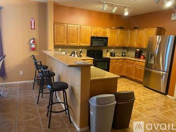 Phoenix apartment for rent - A kitchen with wooden cabinets and a black stove top oven.