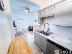 San Diego apartment for rent - A kitchen with a wooden table and a sink.