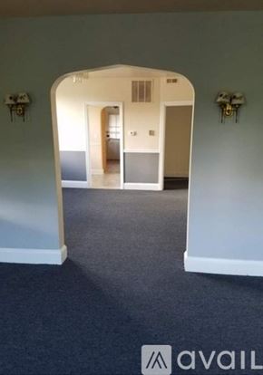 Baltimore apartment for rent - A hallway with a carpeted floor and white walls.