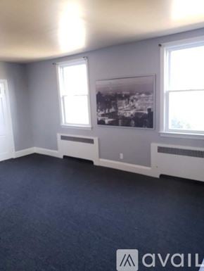 Baltimore apartment for rent - A room with a large window and a framed picture on the wall.