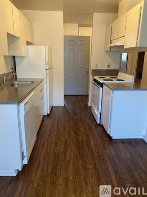Portland apartment for rent - A kitchen with white appliances and wooden floors.
