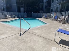 Portland apartment for rent - A pool surrounded by chairs and a fence.