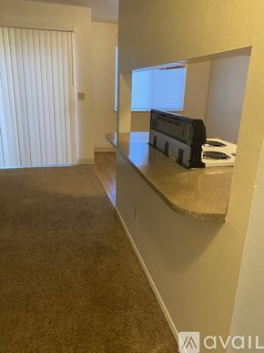 Portland apartment for rent - A room with a carpeted floor and a window with blinds.