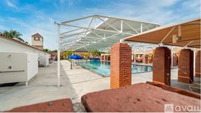 Laguna Woods condo for rent - A pool area with a white building and a pool table.