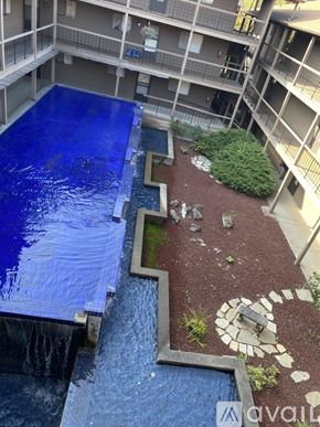 Salem apartment for rent - A blue tarp covers a pool in a courtyard surrounded by apartment buildings.