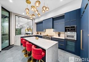 Los Angeles house for rent - A modern kitchen with a marble countertop and red bar stools.