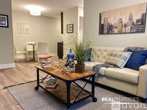 Chicago apartment for rent - A bedroom with a bed, pillows, and a window.