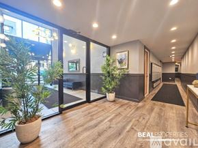 Chicago apartment for rent - A modern interior space with wooden floors and a large window.