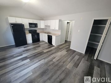 La Crosse apartment for rent - A kitchen with black appliances and white cabinets.