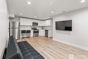 Lehi apartment for rent - A modern kitchen with stainless steel appliances and a wooden floor.
