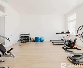 Lehi apartment for rent - A gym with a variety of equipment including a stationary bike, a rowing machine, and a weight bench.