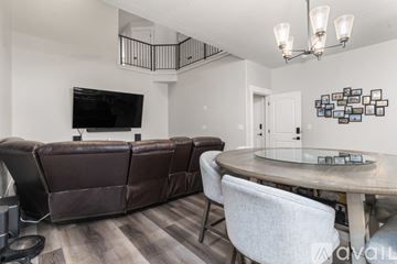 Lehi townhouse for rent - A living room with a brown leather couch and a television.