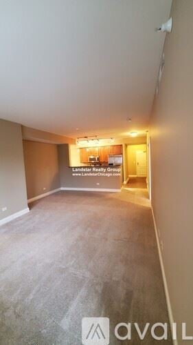 Itasca apartment for rent - A room with a carpeted floor and a sign that says "Landstar Realty Groups" on the wall.