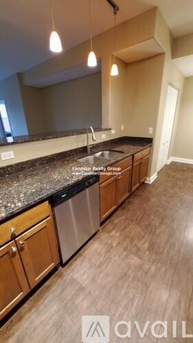 Itasca apartment for rent - A kitchen with wooden cabinets and a granite countertop.