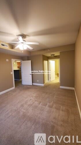Itasca apartment for rent - A room with a carpeted floor and a ceiling fan.