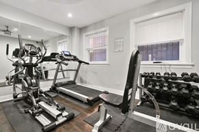 Chicago apartment for rent - A well-equipped home gym with a treadmill, stationary bike, and dumbbells.