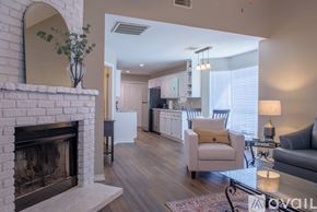 Shreveport townhouse for rent - A living room with a fireplace and a couch.