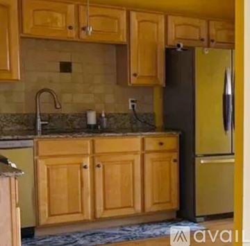 Princeton apartment for rent - A kitchen with wooden cabinets and a granite countertop.