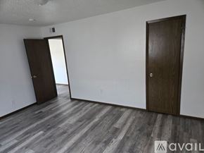Waterloo apartment for rent - A room with wooden flooring and two doors.