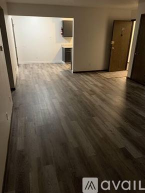 Waterloo apartment for rent - A room with wooden flooring and a door on the right side.