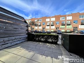Chicago apartment for rent - A view of a building with the text "BEALPROPERTIES AVAIL" on the foreground.