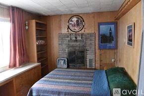 Fall River Mills house for rent - A bedroom with a fireplace and a bed.