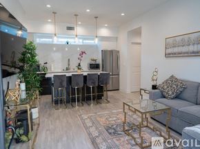 Los Angeles house for rent - A modern kitchen with a bar area and a grey sofa.