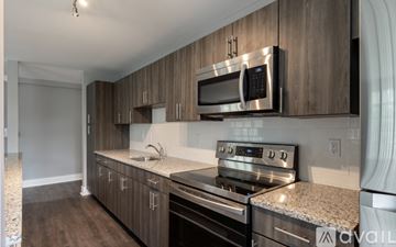 Highland Park apartment for rent - A kitchen with a microwave and oven built into the cabinetry.
