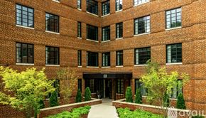 Highland Park apartment for rent - A brick building with a courtyard in front.