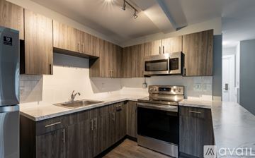 Highland Park apartment for rent - A kitchen with wooden cabinets and stainless steel appliances.