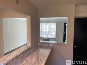Detroit townhouse for rent - A room with a marble countertop and a window with blinds.