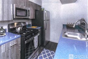 Highland Park apartment for rent - A kitchen with a stove, refrigerator, and microwave.