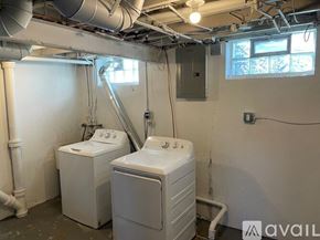 Detroit apartment for rent - A room with two washing machines and a window.
