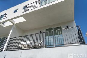 Los Angeles house for rent - A white building with black railings and windows.