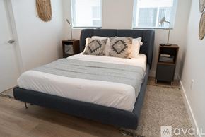 Los Angeles house for rent - A bedroom with a large bed and two lamps on either side.