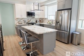Los Angeles house for rent - A kitchen with a marble countertop and stainless steel appliances.