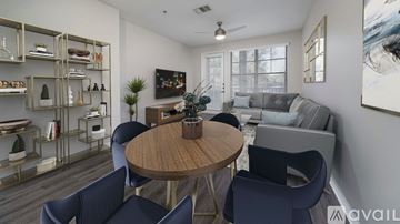 Tampa apartment for rent - A modern living room with a round wooden table surrounded by blue chairs.